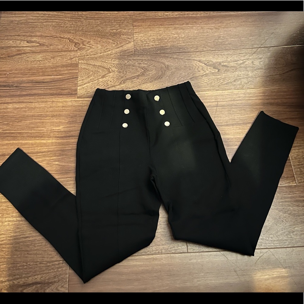 Black leggings with metallic buttons